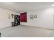 Basement with carpeted flooring, neutral painted walls and built-in shelving along one wall at 4641 W Ponds Cir, Littleton, CO 80123