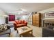 Finished basement area featuring carpeted floors, comfortable furniture, and a brick fireplace at 4641 W Ponds Cir, Littleton, CO 80123