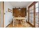 Cozy Dining Area with wooden table, white chairs, and built-in wooden cabinetry for ample storage at 4641 W Ponds Cir, Littleton, CO 80123