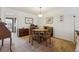 Cozy dining room featuring carpeted floors, comfortable seating, and natural light at 4641 W Ponds Cir, Littleton, CO 80123