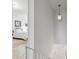 Bright hallway leading to a bedroom with carpeted floors, white walls and natural light at 4641 W Ponds Cir, Littleton, CO 80123