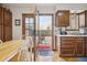 Traditional kitchen with wood cabinets, tile floor, breakfast table and door to outdoor patio at 4641 W Ponds Cir, Littleton, CO 80123