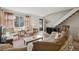 Bright living room with natural light, a staircase, and comfortable seating at 4641 W Ponds Cir, Littleton, CO 80123