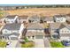 An aerial view shows a residential neighborhood with uniform houses and manicured lawns against a sunny backdrop at 4644 Hatcher Dr, Brighton, CO 80601