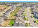 A wide aerial view of a suburban community reveals rows of houses with neat lawns and streets on a sunny day at 4644 Hatcher Dr, Brighton, CO 80601