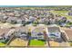 An aerial view of a residential neighborhood shows houses with well-manicured lawns and tree-lined streets at 4644 Hatcher Dr, Brighton, CO 80601