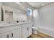 Bright bathroom featuring a double vanity and tub shower combination at 4644 Hatcher Dr, Brighton, CO 80601