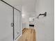 Modern bathroom featuring a glass shower and a view of a bedroom at 4644 Hatcher Dr, Brighton, CO 80601