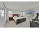 Bedroom featuring a large bed, bedside tables, and a modern dresser at 4644 Hatcher Dr, Brighton, CO 80601