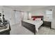Spacious bedroom showcasing a dark wood bed frame and a charming sliding barn door at 4644 Hatcher Dr, Brighton, CO 80601