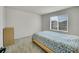 Minimalist bedroom with a large window and a simple bed frame at 4644 Hatcher Dr, Brighton, CO 80601