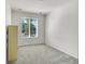 Neutral bedroom with carpet flooring and a large window at 4644 Hatcher Dr, Brighton, CO 80601