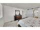 Bedroom with dark wood dresser, Barn door, and view of the bed at 4644 Hatcher Dr, Brighton, CO 80601