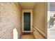 Home entryway with stone veneer walls, modern door, and smooth railing at 4644 Hatcher Dr, Brighton, CO 80601