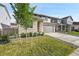 Two-story home featuring a green lawn, stone veneer, and two-car garage at 4644 Hatcher Dr, Brighton, CO 80601