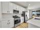 Well-equipped kitchen features stainless steel appliances, white cabinets, and a functional layout at 4644 Hatcher Dr, Brighton, CO 80601
