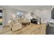 Comfortable living room showcases hardwood floors, staircase, and large window at 4644 Hatcher Dr, Brighton, CO 80601