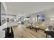Spacious living room with a kitchen island, dining area, and comfortable sofas, ideal for relaxation at 4644 Hatcher Dr, Brighton, CO 80601