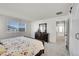 Bright main bedroom featuring a dresser, windows, and sliding barn door at 4644 Hatcher Dr, Brighton, CO 80601