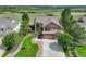 Aerial view of the attractive home featuring a manicured lawn and professional landscaping at 6078 Bridle Path Ln, Parker, CO 80134