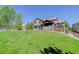 Expansive backyard featuring a well-maintained lawn and charming patio area for outdoor entertaining and relaxation at 6078 Bridle Path Ln, Parker, CO 80134