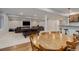 Spacious finished basement with bar seating, a dining table, tv and sitting area at 6078 Bridle Path Ln, Parker, CO 80134
