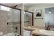 Beautiful bathroom features a shower over tub with glass enclosure and neutral tile at 6078 Bridle Path Ln, Parker, CO 80134