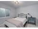 Cozy bedroom with a metal frame bed, small window, neutral walls and plush carpet at 6078 Bridle Path Ln, Parker, CO 80134