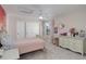 Bright bedroom with a large closet, soft pink accents, and ample natural light at 6078 Bridle Path Ln, Parker, CO 80134