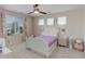 Bright bedroom with a ceiling fan, large window, plush carpet and white sleigh bed at 6078 Bridle Path Ln, Parker, CO 80134
