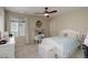 Cozy bedroom with a large window, a comfortable bed, and a built-in desk area at 6078 Bridle Path Ln, Parker, CO 80134