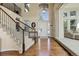 Bright foyer with hardwood floors, a staircase, and a view into the living area at 6078 Bridle Path Ln, Parker, CO 80134