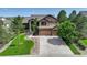 Beautiful two-story home featuring stone accents, a three-car garage, and professionally landscaped yard at 6078 Bridle Path Ln, Parker, CO 80134