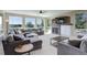 Spacious living area featuring large windows, a stone fireplace, and comfortable sectional sofa at 6078 Bridle Path Ln, Parker, CO 80134