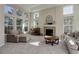 Sunlit living room with a fireplace, large windows, and comfortable seating at 6078 Bridle Path Ln, Parker, CO 80134