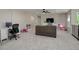 Expansive loft space perfect for work or play featuring a computer desk and a large television at 6078 Bridle Path Ln, Parker, CO 80134