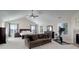 Serene primary bedroom with vaulted ceilings, large windows, and a comfortable sitting area with a fireplace at 6078 Bridle Path Ln, Parker, CO 80134