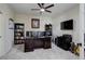 Functional home office with built-in shelving, multiple monitors, and a ceiling fan at 6078 Bridle Path Ln, Parker, CO 80134