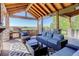 Inviting covered patio features a built-in grill, comfortable seating, and serene views of the surrounding landscape at 6078 Bridle Path Ln, Parker, CO 80134