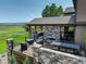 Enjoy this outdoor living space featuring an outdoor fireplace, grill area, and ample seating at 6078 Bridle Path Ln, Parker, CO 80134
