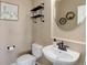 Charming powder room featuring modern fixtures, decorative shelves, and an oval mirror at 6078 Bridle Path Ln, Parker, CO 80134