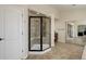 Modern tiled shower with frameless glass door with a corner seat in primary bathroom at 6078 Bridle Path Ln, Parker, CO 80134