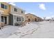 Backyard view of townhomes with snowy yard and patio space at 9719 Albion Ln, Thornton, CO 80229