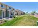 Backyard showing a row of townhomes with green lawns, offering a peaceful living environment at 9719 Albion Ln, Thornton, CO 80229
