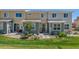 Townhome backyard with sliding glass door, concrete patio, and lush green lawn at 9719 Albion Ln, Thornton, CO 80229
