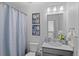 Clean bathroom with a shower-tub combo, framed botanical wall art, and a modern vanity at 9719 Albion Ln, Thornton, CO 80229