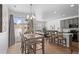 Inviting dining area adjacent to the kitchen, featuring a modern light fixture and sliding glass doors to the backyard at 9719 Albion Ln, Thornton, CO 80229