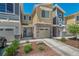 Well-maintained townhome with stone accents, a single-car garage, and a neatly landscaped front yard at 9719 Albion Ln, Thornton, CO 80229