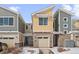 Charming exterior of a modern home featuring a stone facade, attached garage, and well-kept front yard at 9719 Albion Ln, Thornton, CO 80229