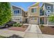 Attractive townhome with stone accents, an attached one-car garage, and lush landscaping at 9719 Albion Ln, Thornton, CO 80229